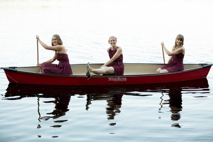 Bridesmaids paddling a canoe
