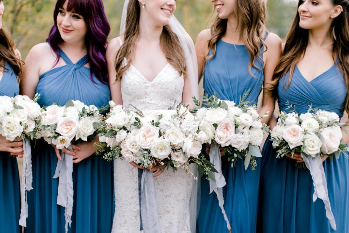 https://cdn0.weddingwire.ca/article-vendor-o/0919/original/1280/jpg/bridesmaids-in-medium-blue-dresses-with-ivory-bouquets-flowers-by-janie_50_919.jpeg