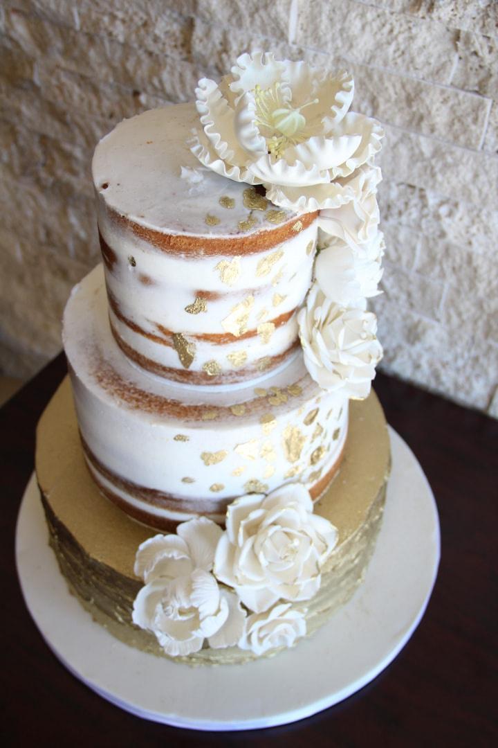 Semi-naked wedding cake with gold leaf