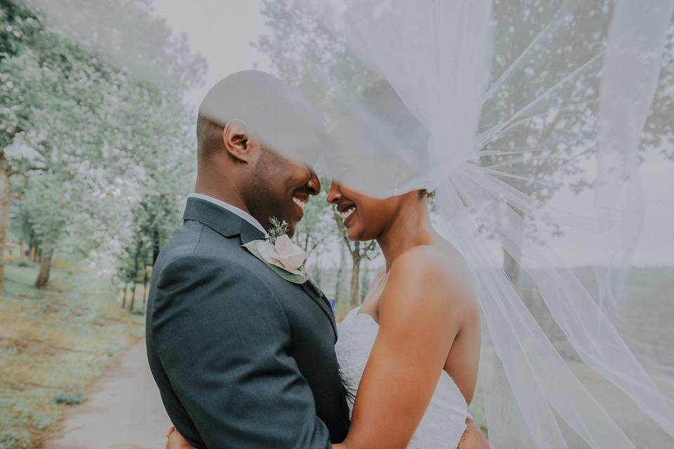 Wedding portrait with bridal veil blowing in the wind