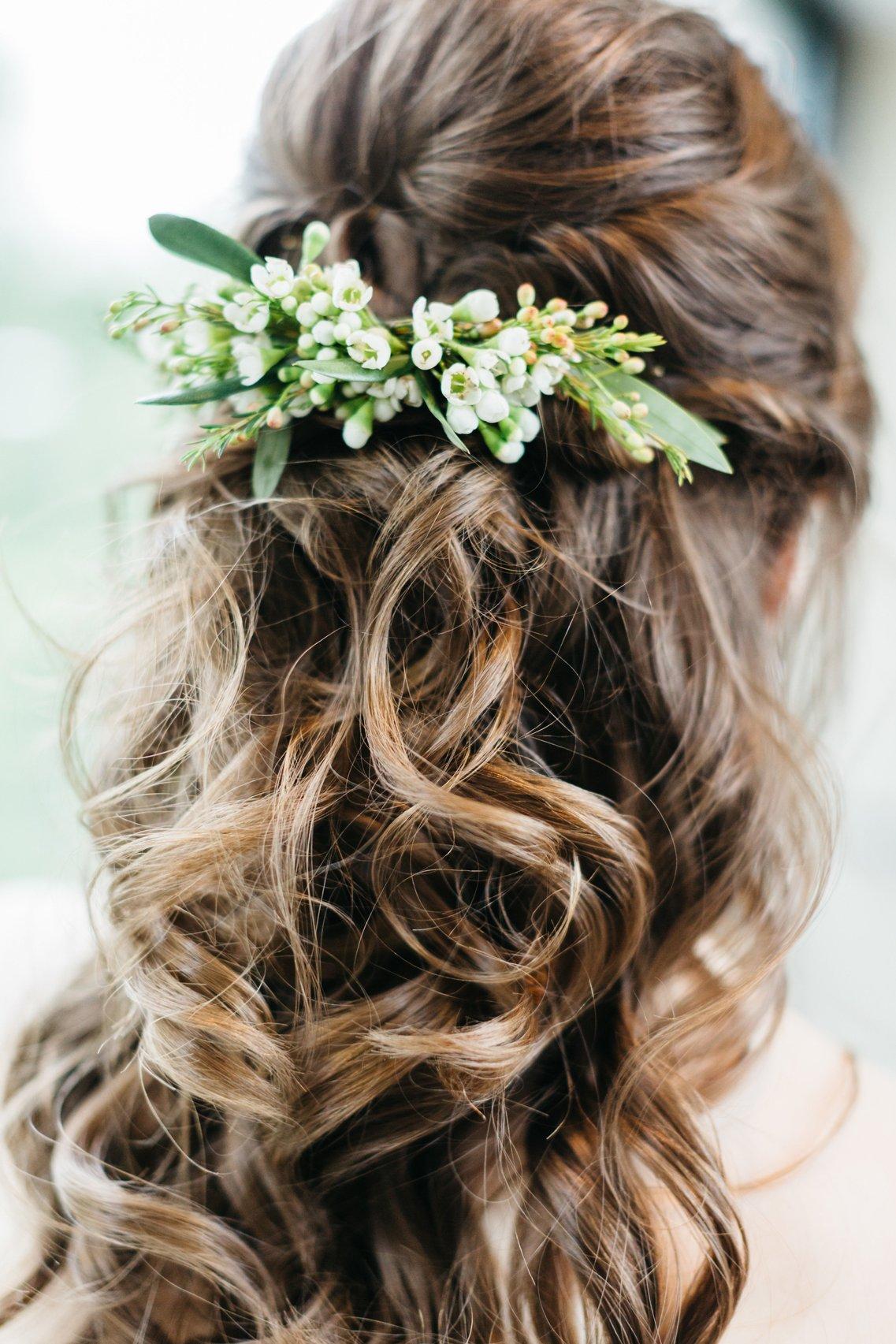 53 Best Wedding Hairstyles for 2023 Brides : Simple Low Bun with White Flower  Hair Pin