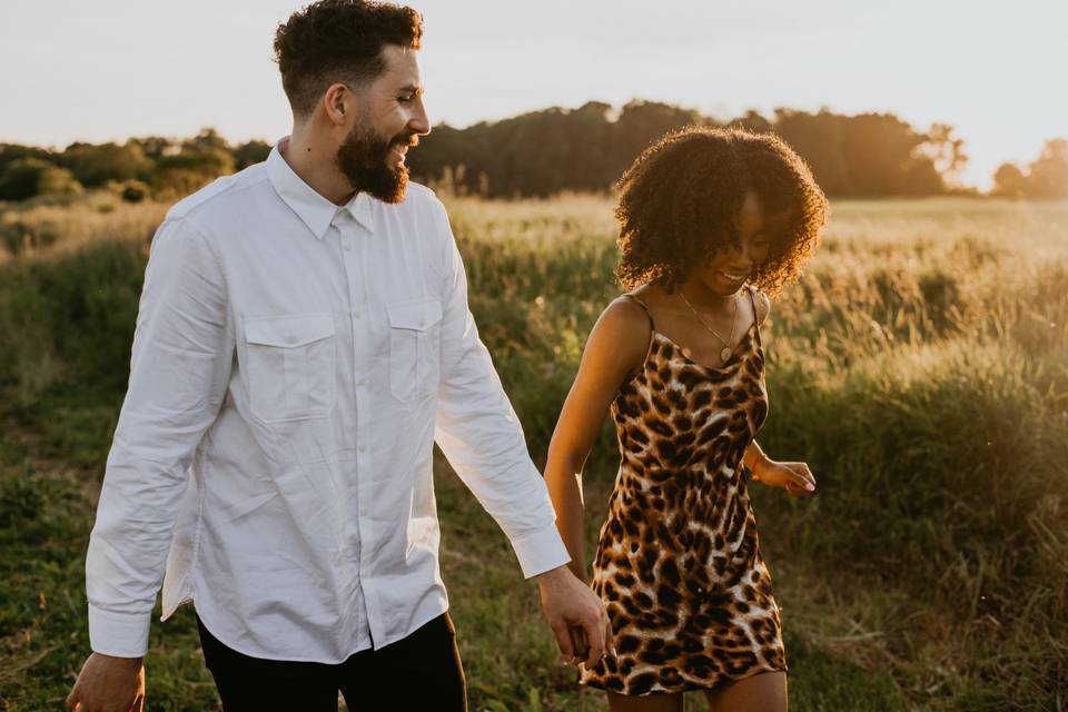 Engaged couple walking in the countryside