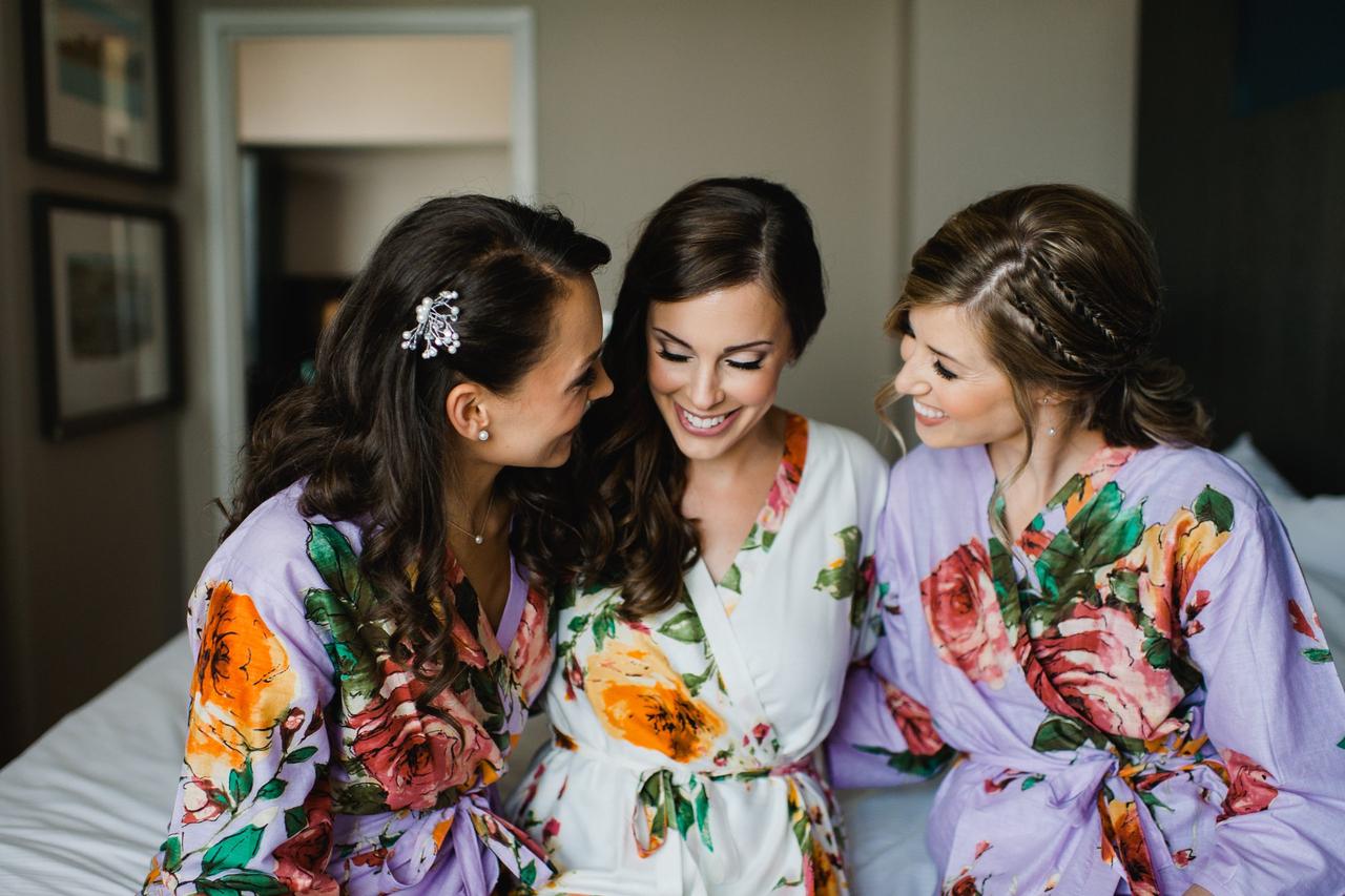 Bride and bridesmaid getting ready wearing floral robes