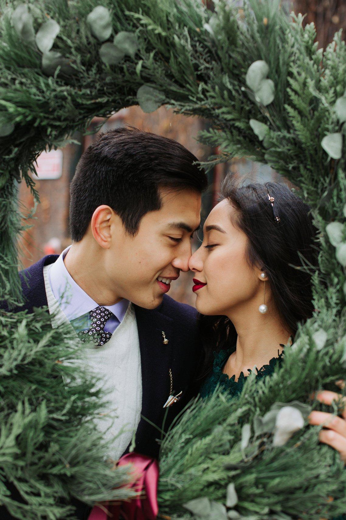 Winter engagement photo with a wreath