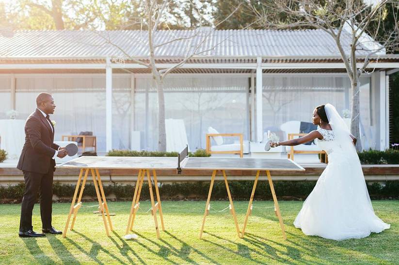 Brida and groom playing ping pong