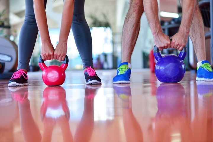 Couple working out together at gym