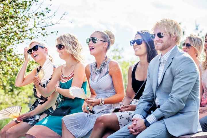 Guests with sunglasses at outdoor ceremony