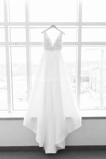 White Wedding Dress Hanging in Window