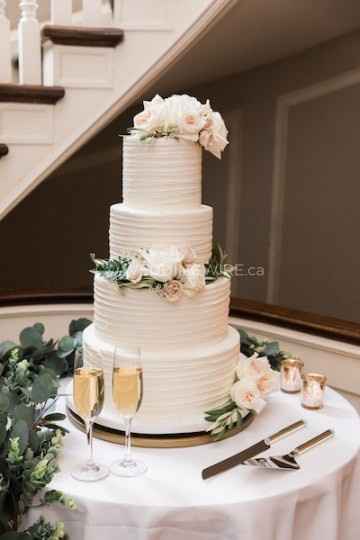White Tiered Buttercream Wedding Cake with White Flowers and Greenery