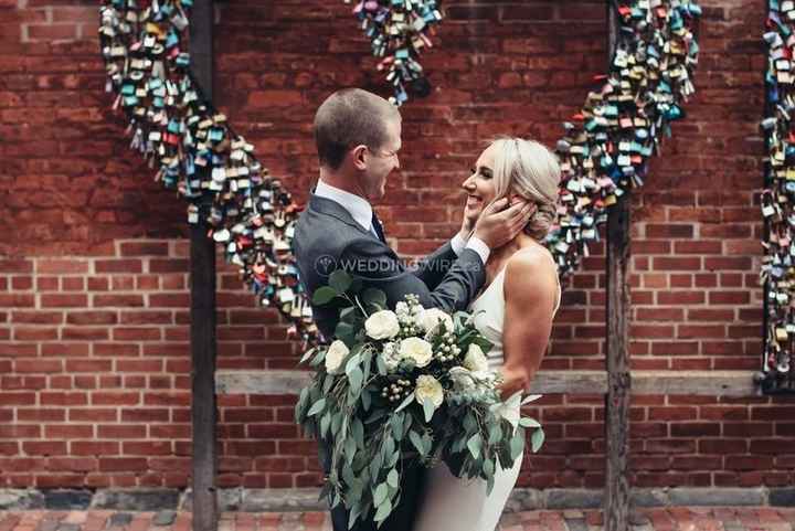 Bride and Groom in front of brick and love locks