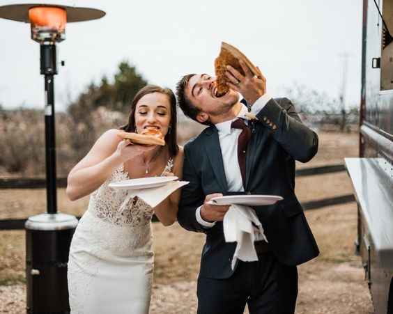 Bride and Groom Eating Pizza Slices