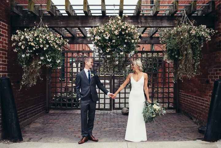 Bride and Groom Holding Hands in Brick Courtyard
