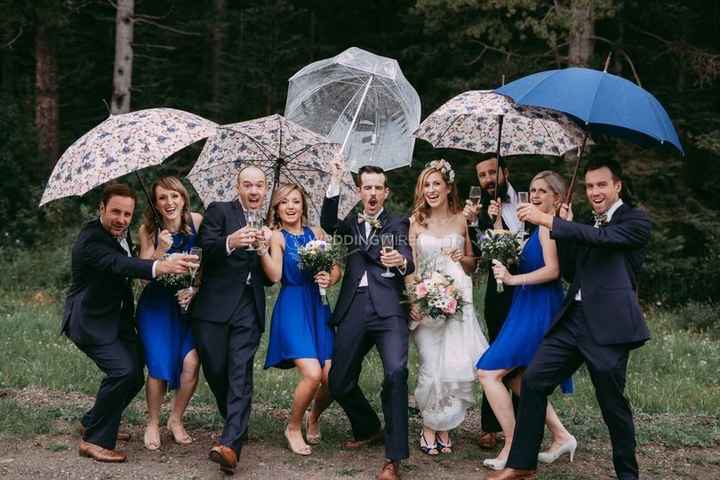 bridal party groomsmen bridesmaids bride groom umbrella rain