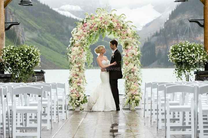 couple at ceremony under floral arch