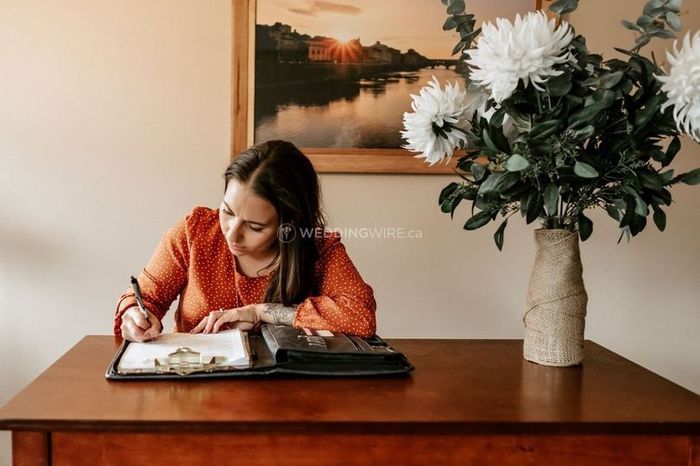 woman writing wedding checklist wedding binder