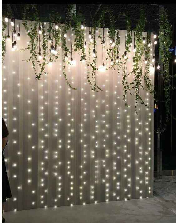 wedding backdrop with greenery and fairy lights