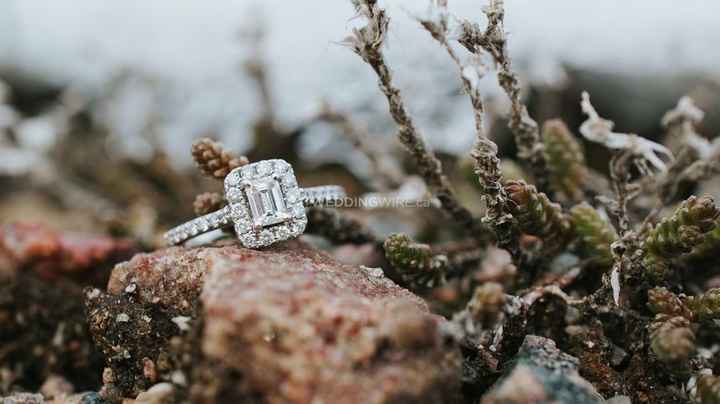silver engagement ring sitting on a rock, cushion cut engagement ring