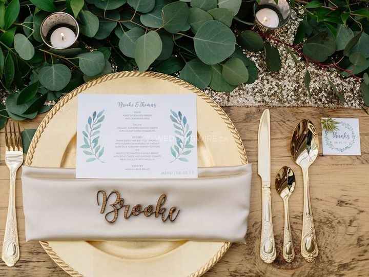 assigned seat place card, gold plate and cutlery with greenery
