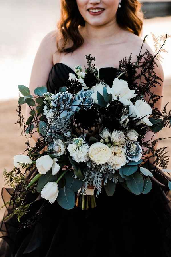 dramatic black bridal bouquet with white roses and greenery