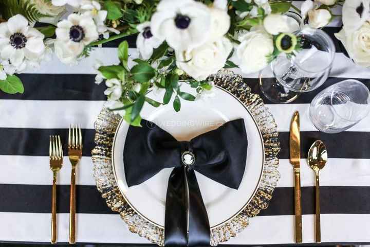 black and white stripped wedding tablescape with gold cutlery and black bow