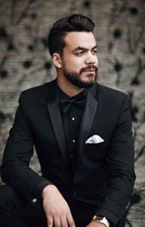 all black grooms outfit, black suit, black skirt, black bow tie