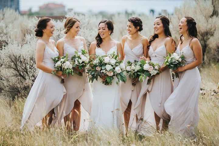 bridal party with matching bouquets of greenery and white flowers