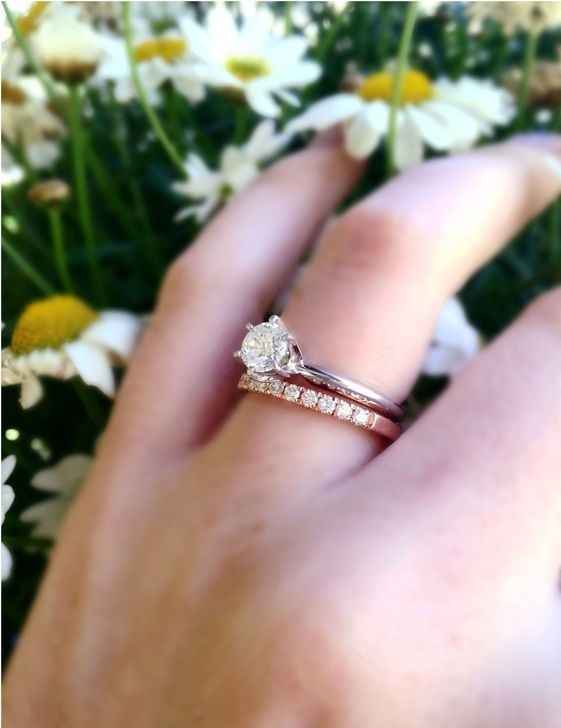 silver solitaire engagement ring with a rose gold band