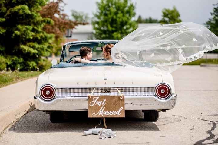 bride and groom in vintage convertible 