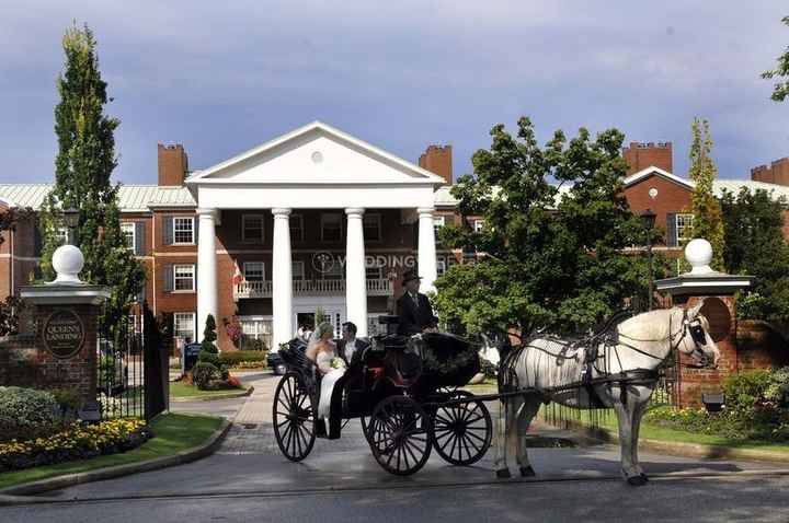 couple in horse drawn carriage leaving venue