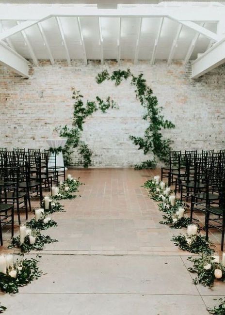 black chiavari chairs at a wedding ceremony, greenery arch