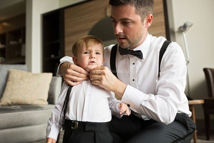 groom and little boy, buttoning shirt