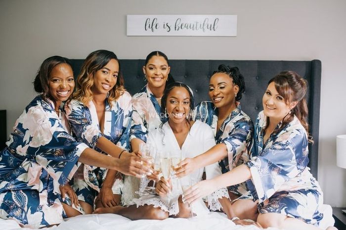 bride and her bridesmaids sitting on bed toasting, silk bridesmaids patterned robes