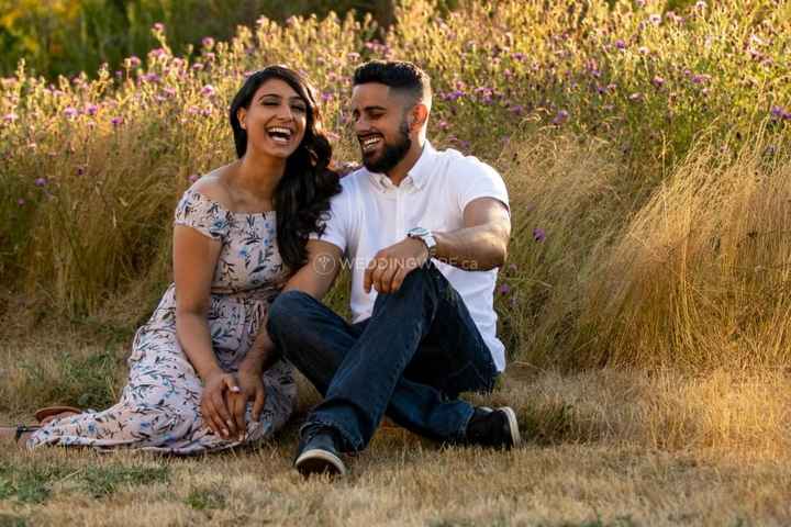 Couple laughing during fall outdoor engagement