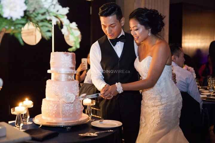 cutting a pink cake