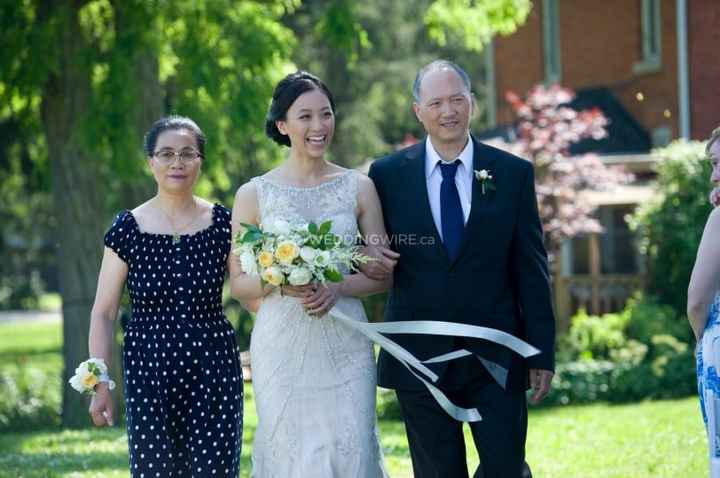 Parents walking daughter down the aisle