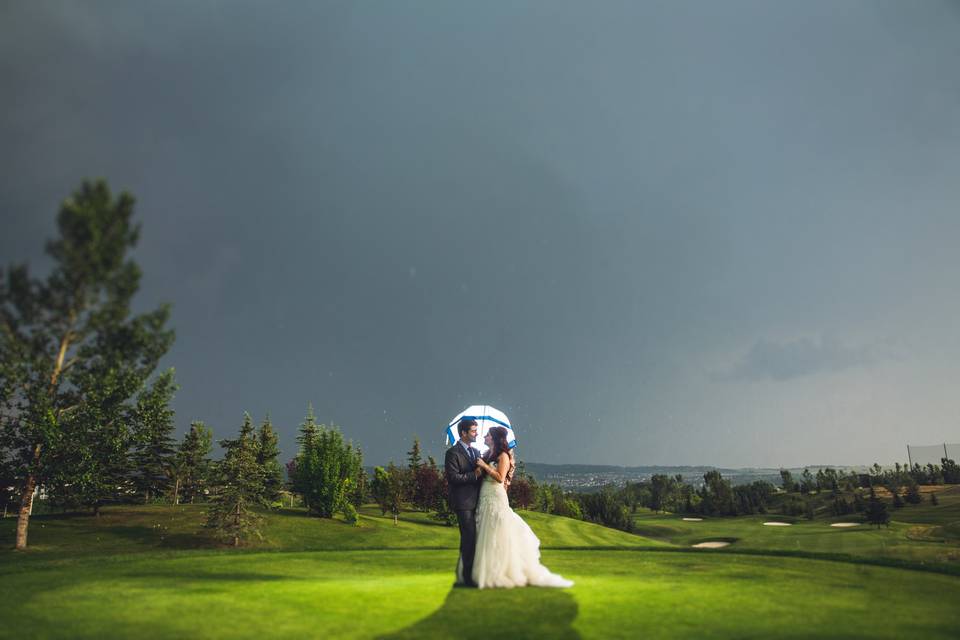 Rainy day wedding with umbrell