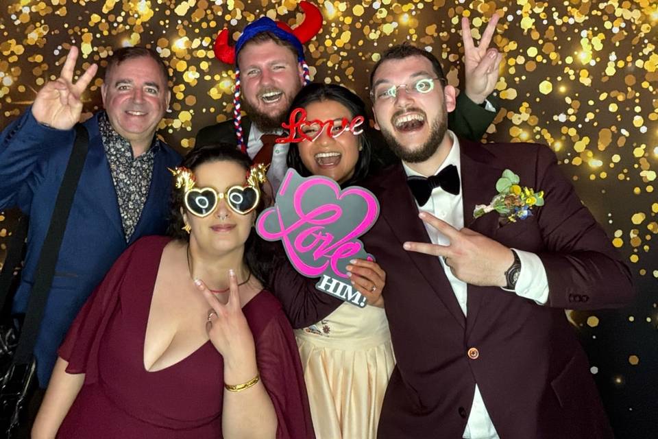 Newlyweds celebrating with friends at the photo booth