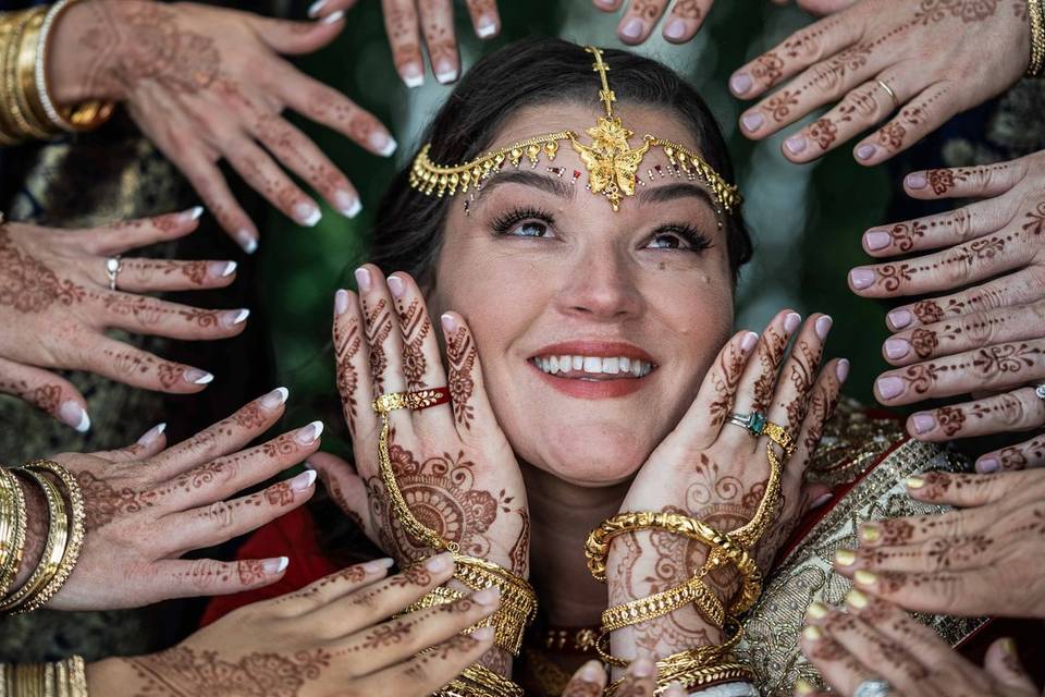 Bride surrounded with henna ha