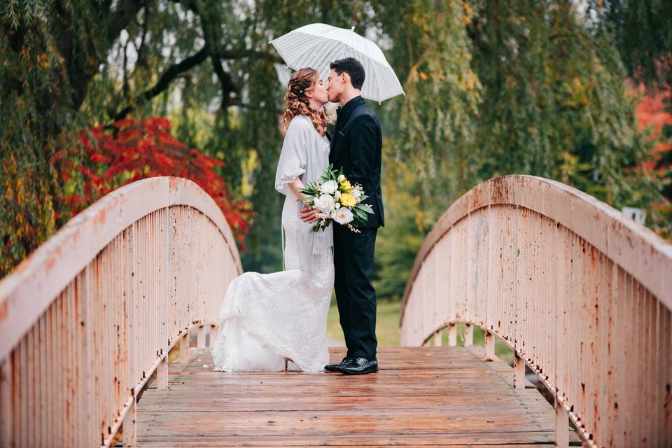 Couple kissing on bridge