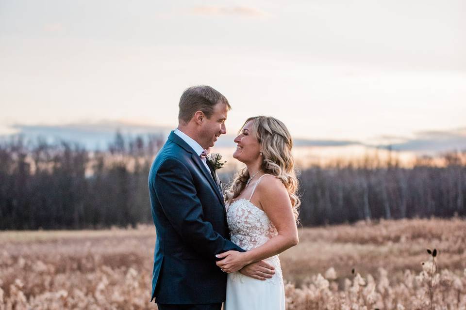 Couple in field on wedding day