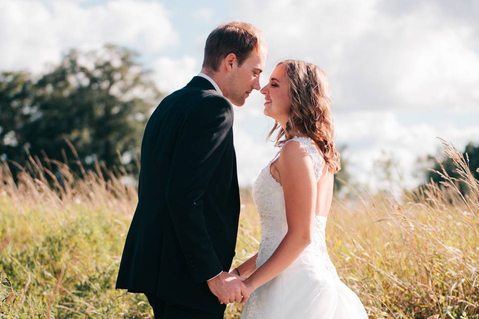 Bride and groom in field