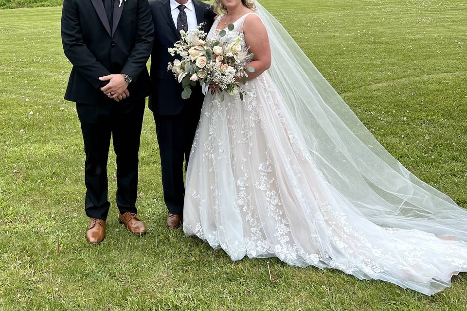 Couple and celebrant smiling