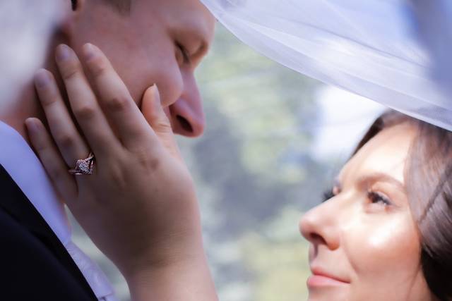 Bride and groom under veil