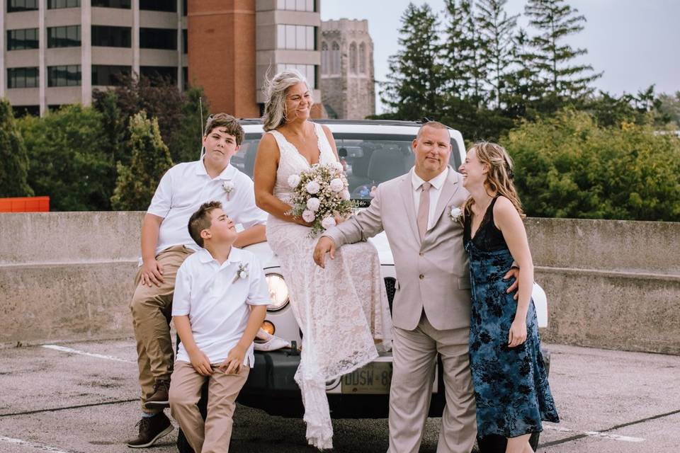 Newlyweds and family on jeep