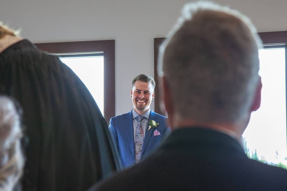 The groom smiling