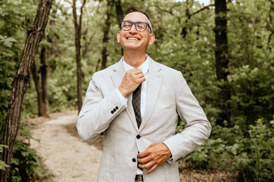 Fixing his tie