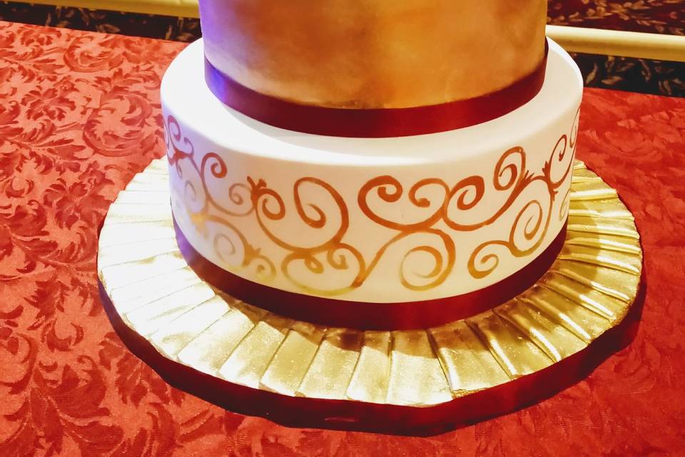 Gold and burgundy wedding cake