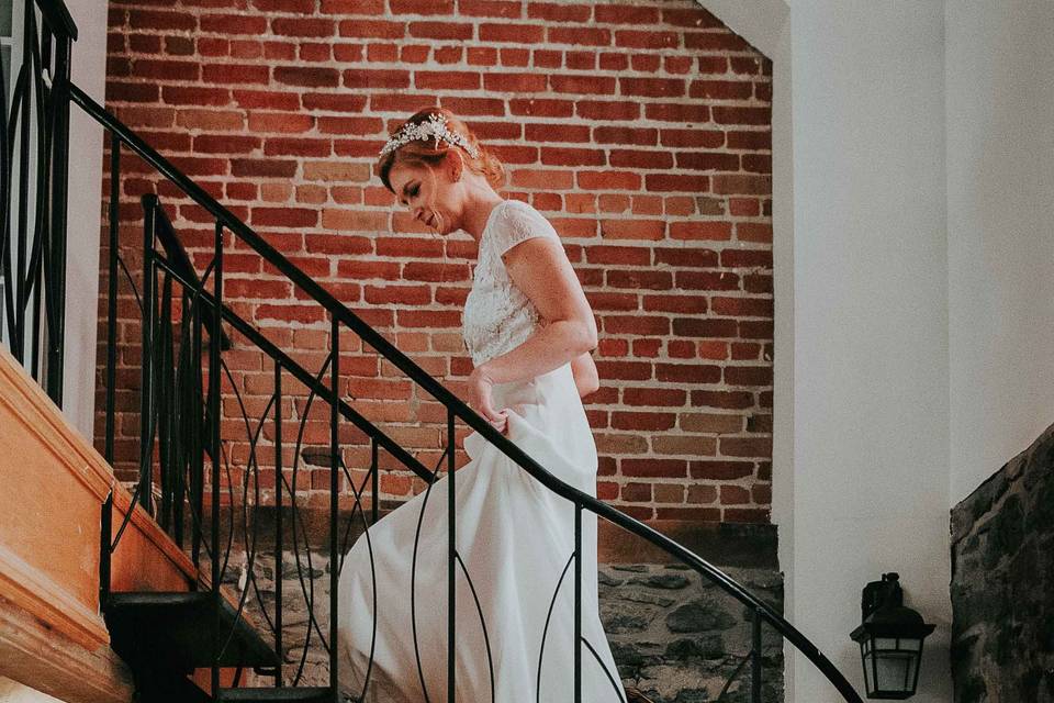 Bride and ornate loft stairs