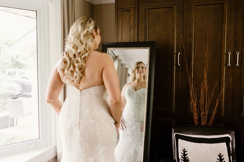 Bride looking through mirror