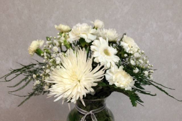 Cream flowers in vase on table